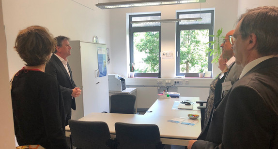 Minister Manne Lucha steht mit Mitarbeitenden der Ergänzenden unabhängigen Teilhabeberatung im Landkreis Schwäbisch Hall in deren Büro.