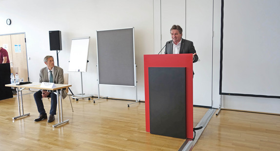 Sozial- und Integrationsminister Manne Lucha spricht vor Publikum in Veranstaltungssaal