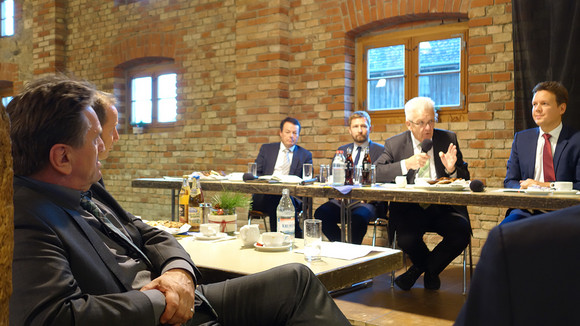 Minister Manne Lucha hört Ministerpräsident Winfried Kretschmann im Blaserhof des Bauernhaus-Museums Allgäu-Oberschwaben zu