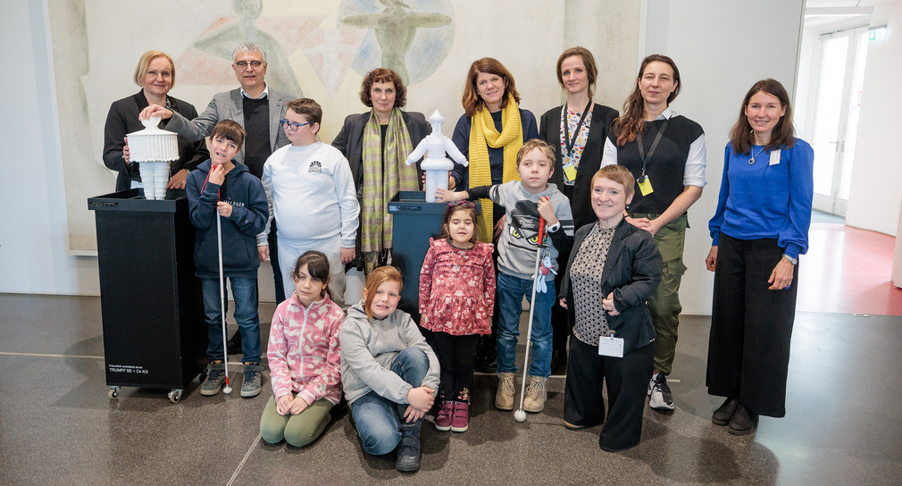 Gruppenfoto: Staatssekretär Arne Braun und Simone Fischer zusammen mit Gruppe von Kindern in der Staatsgalerie Stuttgart