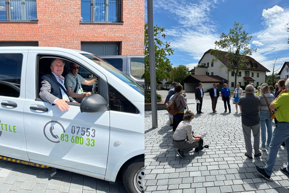 Minister Lucha sitzt gemeinsam mit einem Fahrer in einem Fahrzeug des Linzgau Shuttle.