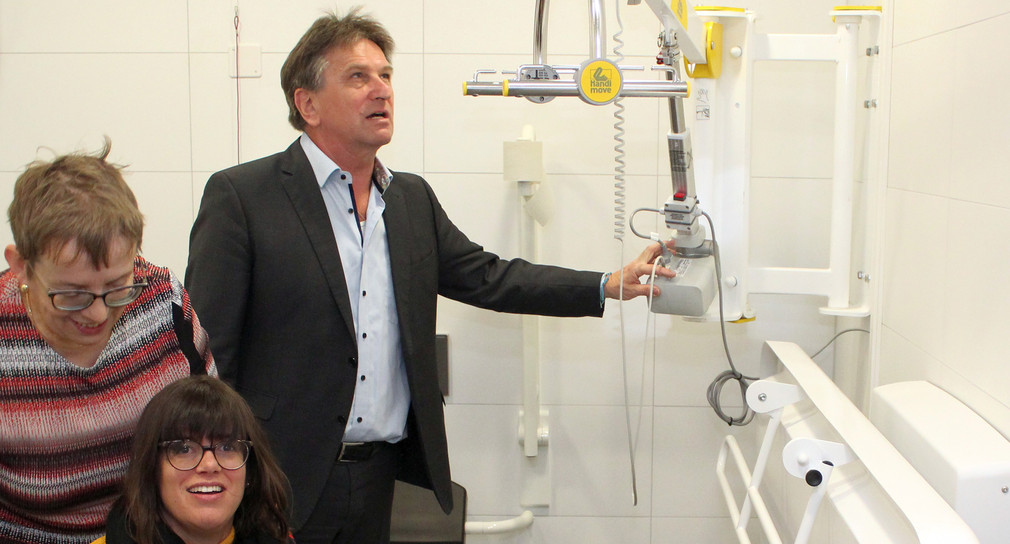 Minister Manne Lucha begutachtet die neu eingerichtete „Toilette für alle“ im Naturschutzzentrum Wurzacher Ried.